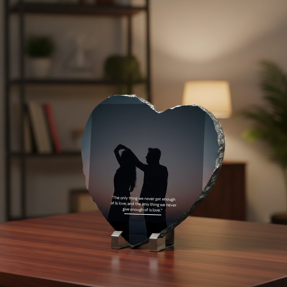 Heart-shaped decorative piece with a silhouette of a couple on a wooden surface.