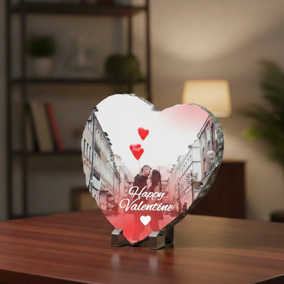 Heart-shaped photo display with a romantic scene and 'Happy Valentine' text on a wooden surface.