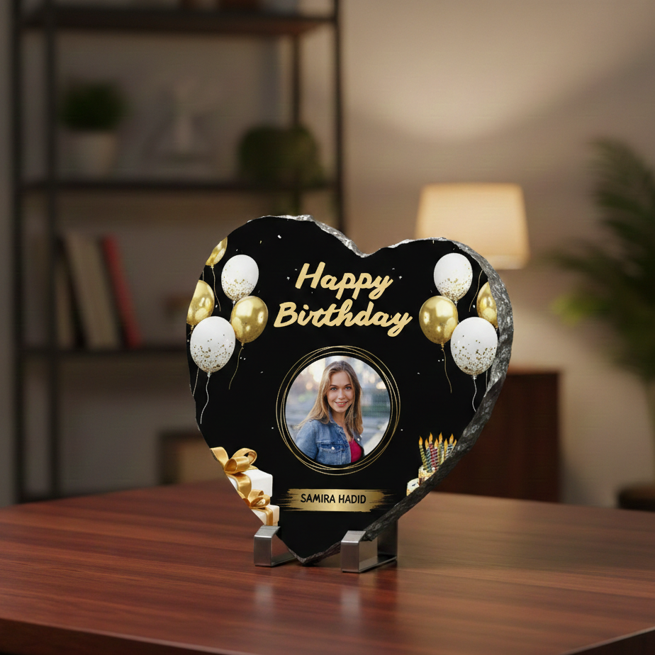 Heart-shaped birthday photo frame with balloons on a wooden surface