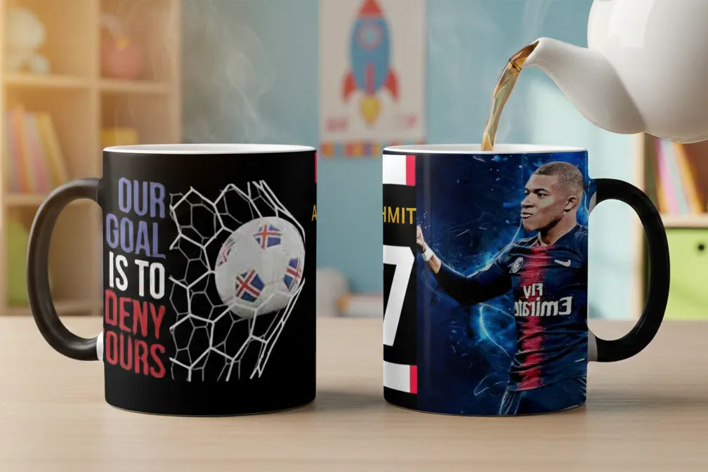 Two mugs with sports-themed designs on a table with a teapot pouring tea.