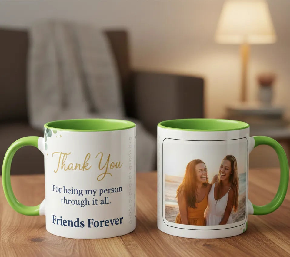 Two mugs with green handles on a wooden table, one with text and the other with a photo of two women.