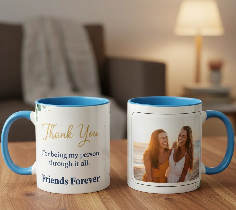 Two mugs with blue interior and handles on a wooden surface, one with text and the other with a photo of two people.